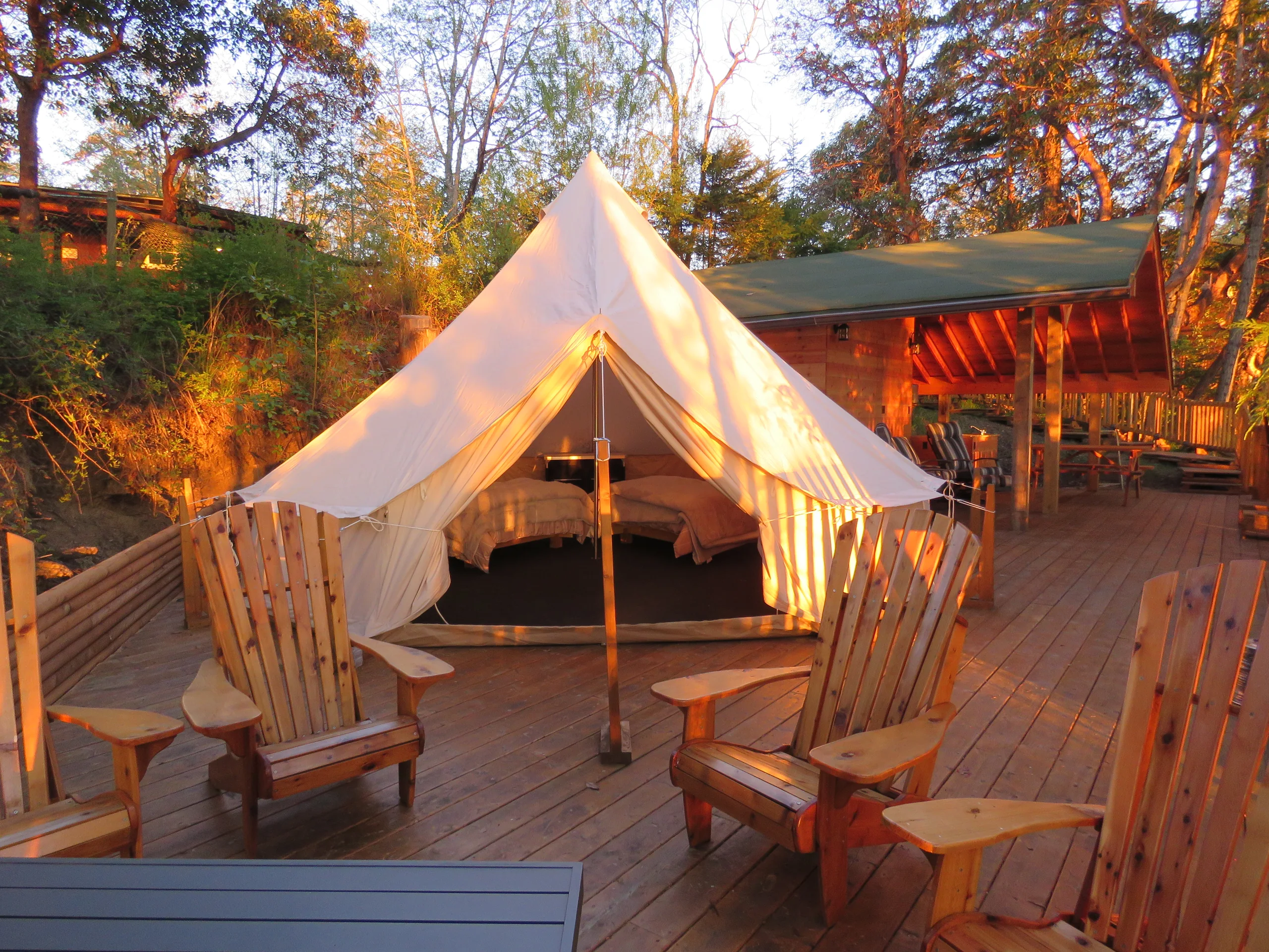 Bell tent on the Glamping Pad deck at golden hour