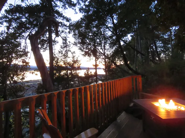Glamping Pad – Fire table overlooking the ocean at sunset
