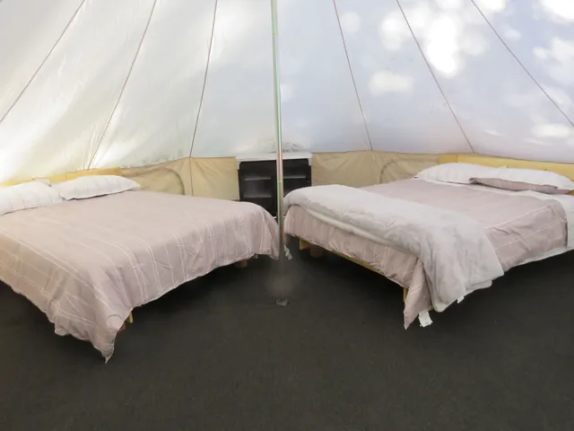 Glamping Pad – Two queen beds inside the bell tent